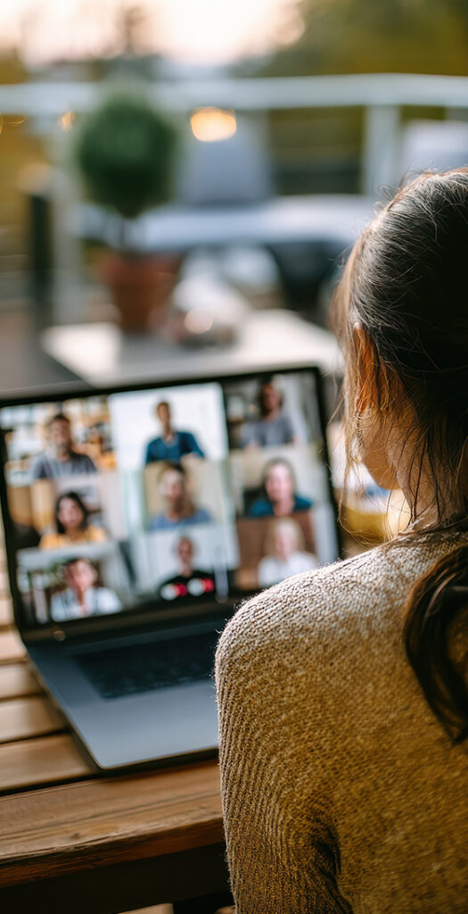 woman on Microsoft Teams video call using laptop with coworkers showing business network connectivity and remote collaboration